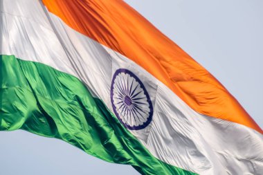 India flag flying high at Connaught Place with pride in blue sky, India flag fluttering, Indian Flag on Independence Day and Republic Day of India, tilt up shot, Waving Indian flag, Har Ghar Tiranga