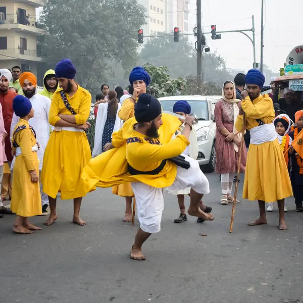 stock image Delhi, India, October 2, 2023 - Sikhs display gatka and martial arts during annual Nagar Kirtan, Traditional, procession on account of birthday of Guru Nanak Dev ji, Nagar Kirtan in East Delhi area