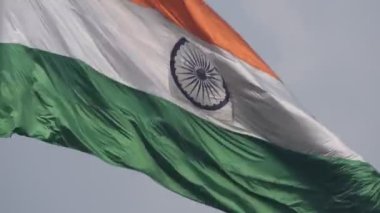 India flag flying high at Connaught Place with pride in blue sky, India flag fluttering, Indian Flag on Independence Day and Republic Day of India, tilt up shot, Waving Indian flag, Har Ghar Tiranga