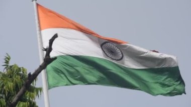 India flag flying high at Connaught Place with pride in blue sky, India flag fluttering, Indian Flag on Independence Day and Republic Day of India, tilt up shot, Waving Indian flag, Har Ghar Tiranga