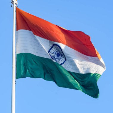 India flag flying high at Connaught Place with pride in blue sky, India flag fluttering, Indian Flag on Independence Day and Republic Day of India, tilt up shot, Waving Indian flag, Har Ghar Tiranga