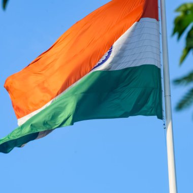 India flag flying high at Connaught Place with pride in blue sky, India flag fluttering, Indian Flag on Independence Day and Republic Day of India, tilt up shot, Waving Indian flag, Har Ghar Tiranga