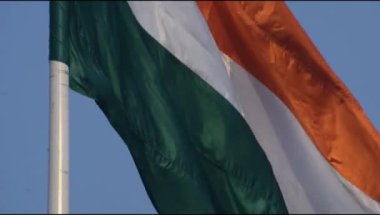 India flag flying high at Connaught Place with pride in blue sky, India flag fluttering, Indian Flag on Independence Day and Republic Day of India, tilt up shot, Waving Indian flag, Har Ghar Tiranga