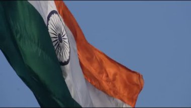 India flag flying high at Connaught Place with pride in blue sky, India flag fluttering, Indian Flag on Independence Day and Republic Day of India, tilt up shot, Waving Indian flag, Har Ghar Tiranga