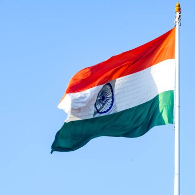 India flag flying high at Connaught Place with pride in blue sky, India flag fluttering, Indian Flag on Independence Day and Republic Day of India, tilt up shot, Waving Indian flag, Har Ghar Tiranga