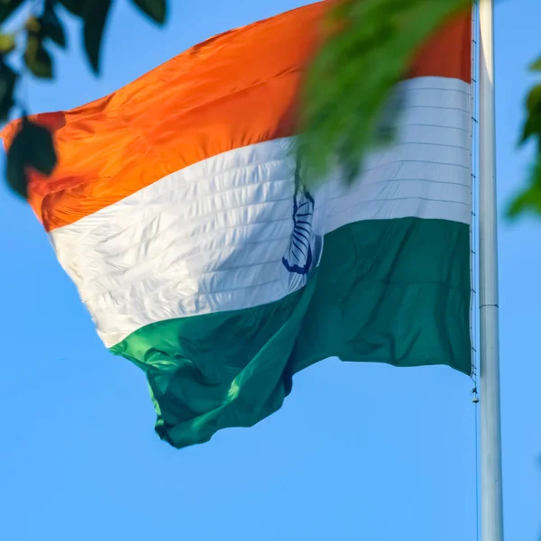 stock image India flag flying high at Connaught Place with pride in blue sky, India flag fluttering, Indian Flag on Independence Day and Republic Day of India, tilt up shot, Waving Indian flag, Har Ghar Tiranga