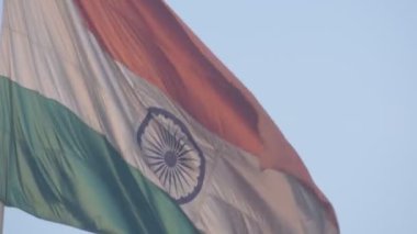India flag flying high at Connaught Place with pride in blue sky, India flag fluttering, Indian Flag on Independence Day and Republic Day of India, tilt up shot, Waving Indian flag, Har Ghar Tiranga