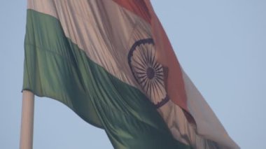 India flag flying high at Connaught Place with pride in blue sky, India flag fluttering, Indian Flag on Independence Day and Republic Day of India, tilt up shot, Waving Indian flag, Har Ghar Tiranga