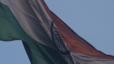 India flag flying high at Connaught Place with pride in blue sky, India flag fluttering, Indian Flag on Independence Day and Republic Day of India, tilt up shot, Waving Indian flag, Har Ghar Tiranga