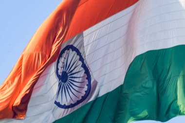 India flag flying high at Connaught Place with pride in blue sky, India flag fluttering, Indian Flag on Independence Day and Republic Day of India, tilt up shot, Waving Indian flag, Har Ghar Tiranga