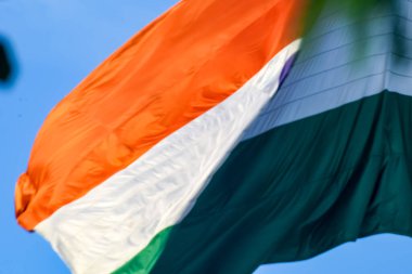 India flag flying high at Connaught Place with pride in blue sky, India flag fluttering, Indian Flag on Independence Day and Republic Day of India, tilt up shot, Waving Indian flag, Har Ghar Tiranga