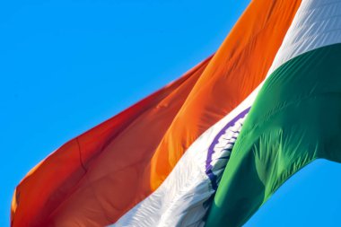India flag flying high at Connaught Place with pride in blue sky, India flag fluttering, Indian Flag on Independence Day and Republic Day of India, tilt up shot, Waving Indian flag, Har Ghar Tiranga