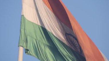 India flag flying high at Connaught Place with pride in blue sky, India flag fluttering, Indian Flag on Independence Day and Republic Day of India, tilt up shot, Waving Indian flag, Har Ghar Tiranga