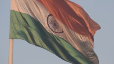 India flag flying high at Connaught Place with pride in blue sky, India flag fluttering, Indian Flag on Independence Day and Republic Day of India, tilt up shot, Waving Indian flag, Har Ghar Tiranga