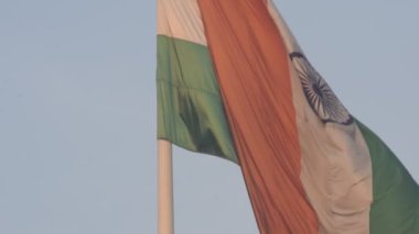India flag flying high at Connaught Place with pride in blue sky, India flag fluttering, Indian Flag on Independence Day and Republic Day of India, tilt up shot, Waving Indian flag, Har Ghar Tiranga