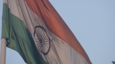 India flag flying high at Connaught Place with pride in blue sky, India flag fluttering, Indian Flag on Independence Day and Republic Day of India, tilt up shot, Waving Indian flag, Har Ghar Tiranga