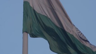 India flag flying high at Connaught Place with pride in blue sky, India flag fluttering, Indian Flag on Independence Day and Republic Day of India, tilt up shot, Waving Indian flag, Har Ghar Tiranga