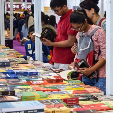Delhi, Hindistan, 17 Şubat 2024 - Çeşitli yaş gruplarından insanlar Delhi Uluslararası Kitap Fuarı 'ndaki bir kitapçıda çeşitli kitaplar okuyor, Bharat Mandapam kompleksindeki Yıllık Kitap Fuarı' nda kitaplar