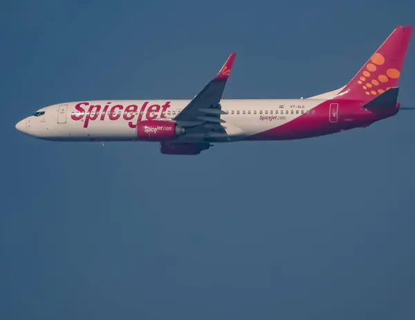 stock image New Delhi, India, December 25 2023 - Spicejet Airbus A320 take off from Indra Gandhi International Airport Delhi, Spicejet domestic aeroplane flying in the blue sky during day time