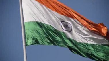 India flag flying high at Connaught Place with pride in blue sky, India flag fluttering, Indian Flag on Independence Day and Republic Day of India, tilt up shot, Waving Indian flag, Har Ghar Tiranga