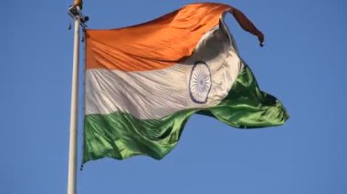 India flag flying high at Connaught Place with pride in blue sky, India flag fluttering, Indian Flag on Independence Day and Republic Day of India, tilt up shot, Waving Indian flag, Har Ghar Tiranga