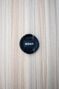 New Delhi, India, March 01 2024 - Nikon lens cap on plain background, Nikon DSLR kit shoot. clipart