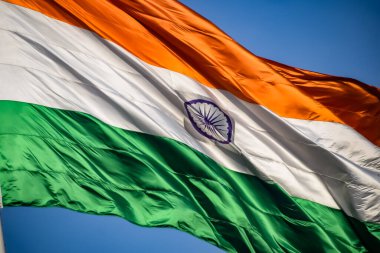 India flag flying high at Connaught Place with pride in blue sky, India flag fluttering, Indian Flag on Independence Day and Republic Day of India, tilt up shot, Waving Indian flag, Har Ghar Tiranga