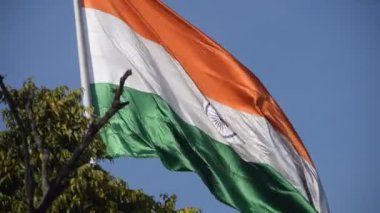 India flag flying high at Connaught Place with pride in blue sky, India flag fluttering, Indian Flag on Independence Day and Republic Day of India, tilt up shot, Waving Indian flag, Har Ghar Tiranga