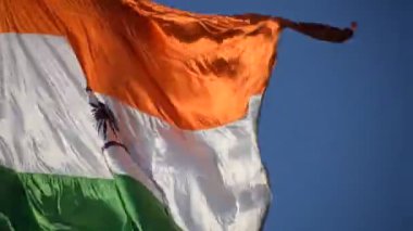India flag flying high at Connaught Place with pride in blue sky, India flag fluttering, Indian Flag on Independence Day and Republic Day of India, tilt up shot, Waving Indian flag, Har Ghar Tiranga