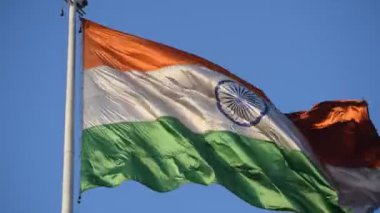 India flag flying high at Connaught Place with pride in blue sky, India flag fluttering, Indian Flag on Independence Day and Republic Day of India, tilt up shot, Waving Indian flag, Har Ghar Tiranga