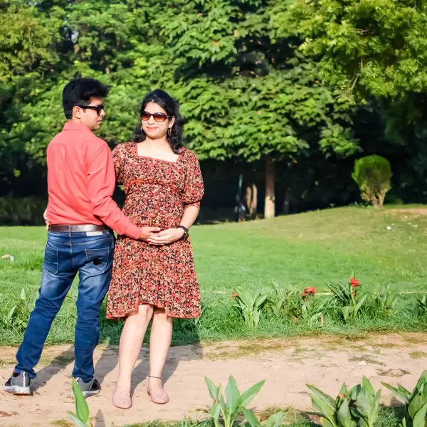 Indian couple posing for Maternity shoot pose for welcoming new born baby in Lodhi Garden in Delhi India, Maternity photo shoot done by parents for welcoming their child, Pre Baby Photo Shoot