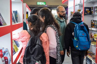 Delhi, Hindistan, 17 Şubat 2024 - Çeşitli yaş gruplarından insanlar Delhi Uluslararası Kitap Fuarı 'ndaki bir kitapçıda çeşitli kitaplar okuyor, Bharat Mandapam kompleksindeki Yıllık Kitap Fuarı' nda kitaplar