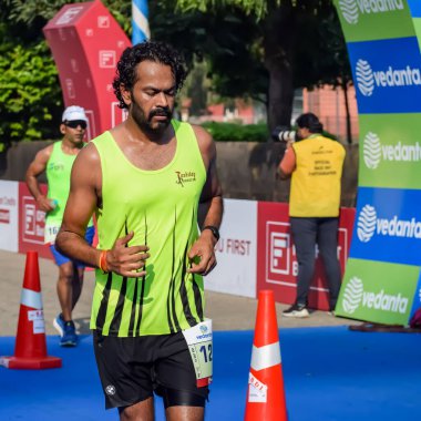 Yeni Delhi, Hindistan - 15 Ekim 2023 - Bitmek üzere olan maraton katılımcılarının bitiş çizgisini geçmek üzere olan Delhi Yarı Maratonu 2023