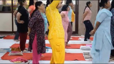 Yeni Delhi, Hindistan, 19 Nisan 2024 - Balaji Tapınağı, Vivek Vihar, Uluslararası Yoga Günü, tapınaktaki yoga sınıfına katılan büyük bir grup yetişkin için grup yoga oturumu