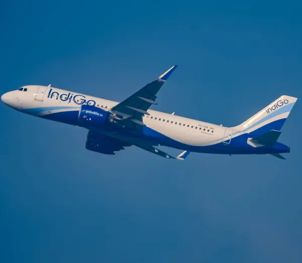 stock image New Delhi, India, December 25 2023 - Indigo Airbus A320 take off from Indra Gandhi International Airport Delhi, Indigo domestic aeroplane flying in the blue sky during day time