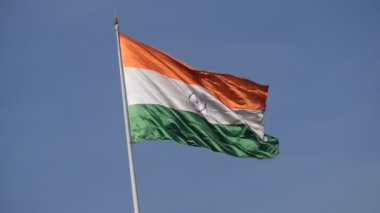 India flag flying high at Connaught Place with pride in blue sky, India flag fluttering, Indian Flag on Independence Day and Republic Day of India, tilt up shot, Waving Indian flag, Har Ghar Tiranga