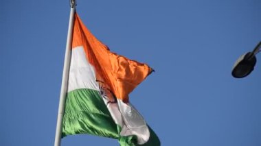India flag flying high at Connaught Place with pride in blue sky, India flag fluttering, Indian Flag on Independence Day and Republic Day of India, tilt up shot, Waving Indian flag, Har Ghar Tiranga