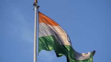 India flag flying high at Connaught Place with pride in blue sky, India flag fluttering, Indian Flag on Independence Day and Republic Day of India, tilt up shot, Waving Indian flag, Har Ghar Tiranga