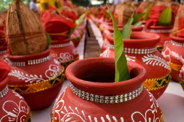 Kalash with coconut and mango leaf with floral decoration earthen pots containing sacred water. Kalash for hindu puja during Jagannath Temple Mangal Kalash Yatra, front view, closeup clipart