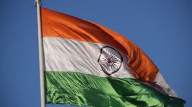 India flag flying high at Connaught Place with pride in blue sky, India flag fluttering, Indian Flag on Independence Day and Republic Day of India, tilt up shot, Waving Indian flag, Har Ghar Tiranga