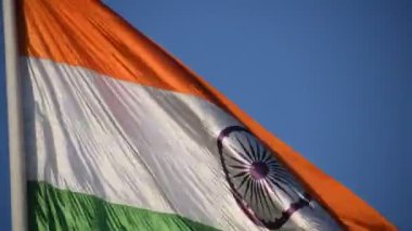 India flag flying high at Connaught Place with pride in blue sky, India flag fluttering, Indian Flag on Independence Day and Republic Day of India, tilt up shot, Waving Indian flag, Har Ghar Tiranga