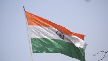 India flag flying high at Connaught Place with pride in blue sky, India flag fluttering, Indian Flag on Independence Day and Republic Day of India, tilt up shot, Waving Indian flag, Har Ghar Tiranga