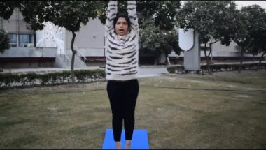 Young Indian woman practicing yoga outdoor in a park. Beautiful girl practice basic yoga pose. Calmness and relax, female happiness. Basic Yoga poses outdoor 