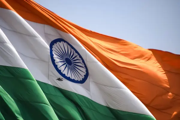 stock image India flag flying high at Connaught Place with pride in blue sky, India flag fluttering, Indian Flag on Independence Day and Republic Day of India, tilt up shot, Waving Indian flag, Har Ghar Tiranga