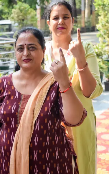 stock image New Delhi, India - May 25 2024 - Unidentified people showing their ink-marked fingers after casting votes in front of polling booth of east Delhi area for general Lok Sabha Elections 2024