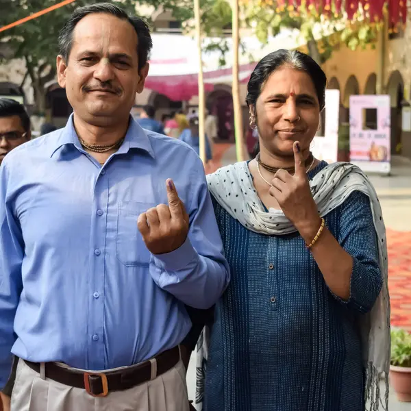 stock image New Delhi, India - May 25 2024 - Unidentified people showing their ink-marked fingers after casting votes in front of polling booth of east Delhi area for general Lok Sabha Elections 2024