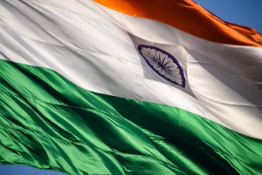 India flag flying high at Connaught Place with pride in blue sky, India flag fluttering, Indian Flag on Independence Day and Republic Day of India, tilt up shot, Waving Indian flag, Har Ghar Tiranga