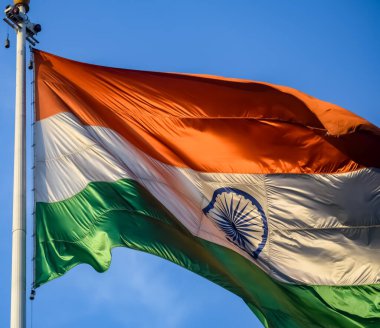 India flag flying high at Connaught Place with pride in blue sky, India flag fluttering, Indian Flag on Independence Day and Republic Day of India, tilt up shot, Waving Indian flag, Har Ghar Tiranga