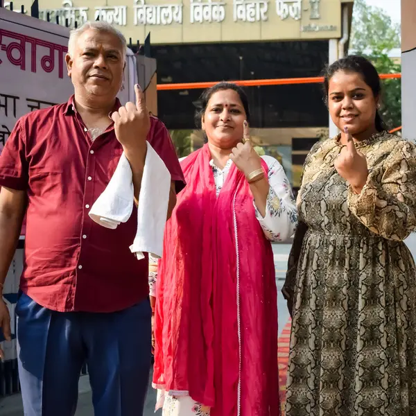 stock image New Delhi, India - May 25 2024 - Unidentified people showing their ink-marked fingers after casting votes in front of polling booth of east Delhi area for general Lok Sabha Elections 2024