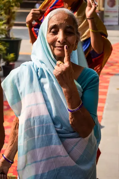 stock image New Delhi, India - May 25 2024 - Unidentified people showing their ink-marked fingers after casting votes in front of polling booth of east Delhi area for general Lok Sabha Elections 2024